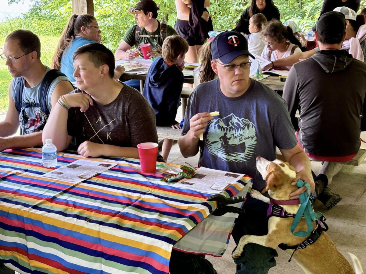 People sitting at a picnic shelter