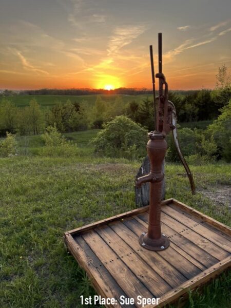 Old water pump in sunset